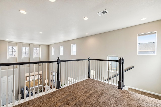 hallway featuring visible vents, recessed lighting, baseboards, and carpet floors