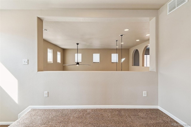 carpeted spare room with visible vents, recessed lighting, a ceiling fan, and baseboards