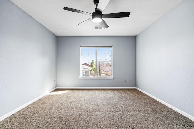 empty room with ceiling fan, carpet, visible vents, and baseboards