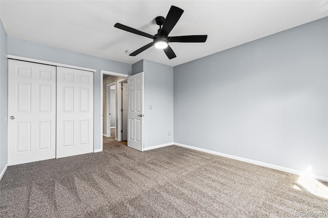 unfurnished bedroom featuring a closet, baseboards, carpet floors, and ceiling fan