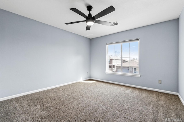 carpeted empty room featuring a ceiling fan, baseboards, and visible vents