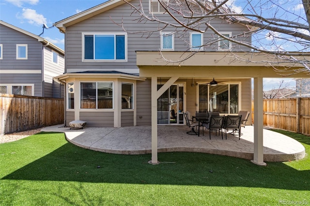 rear view of property with ceiling fan, a yard, a patio, and a fenced backyard