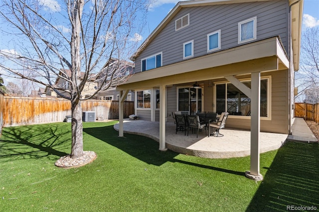 back of property with central air condition unit, a lawn, a patio, a fenced backyard, and ceiling fan