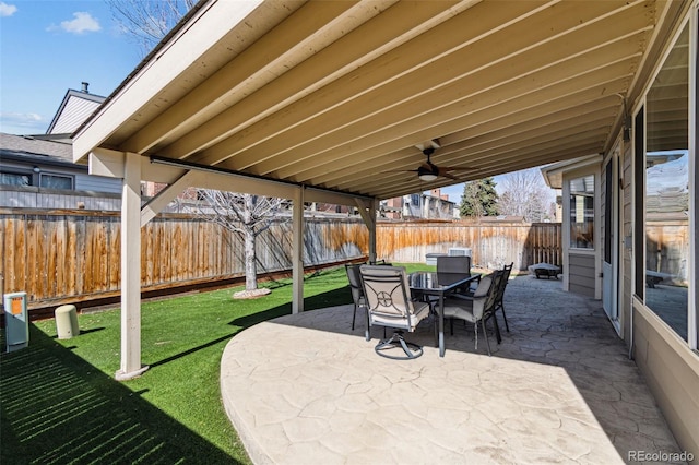 view of patio with outdoor dining space and a fenced backyard