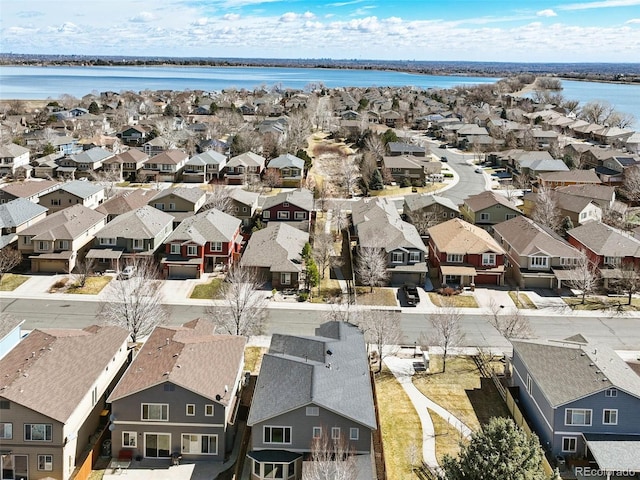 drone / aerial view featuring a residential view and a water view