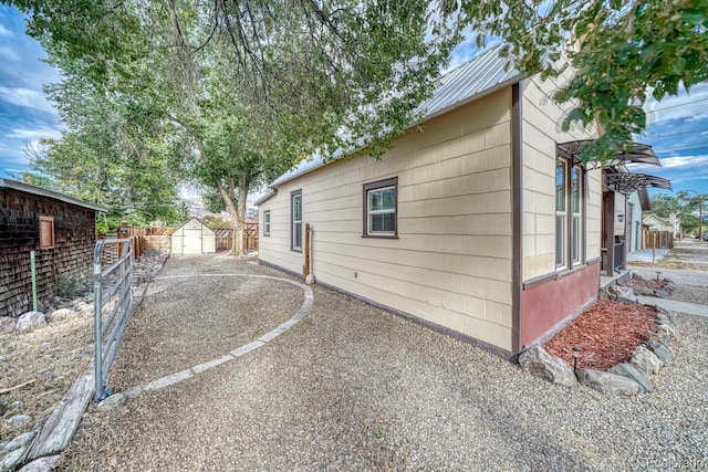 view of property exterior featuring a storage unit