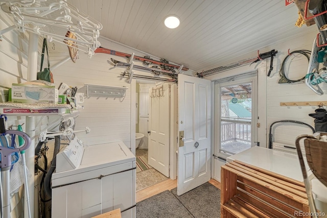 laundry room with separate washer and dryer and hardwood / wood-style flooring