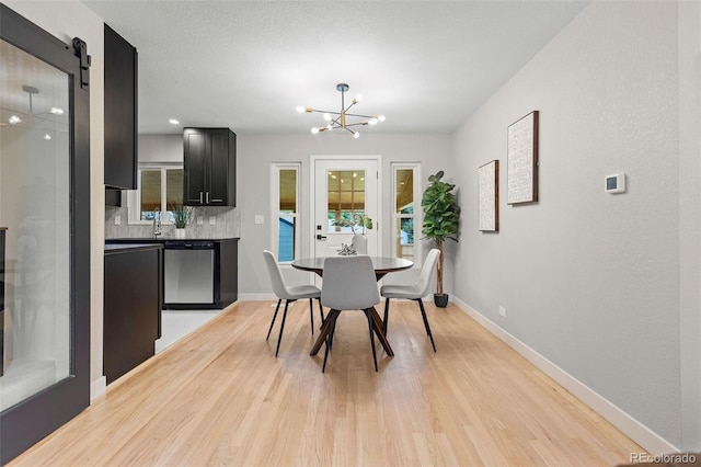 1310 E Amherst Ave, Englewood, CO 80113 - dining space with a chandelier and light wood-type flooring