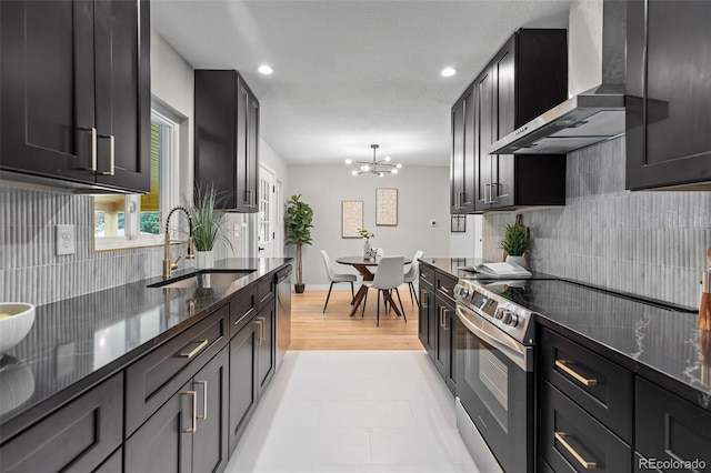 1310 E Amherst Ave, Englewood, CO 80113 - kitchen featuring wall chimney exhaust hood, appliances with stainless steel finishes, decorative backsplash, recessed lighting, and dark stone counters