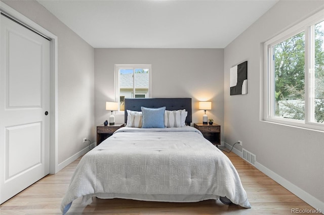 1310 E Amherst Ave, Englewood, CO 80113 - bedroom with multiple windows and light wood-type flooring