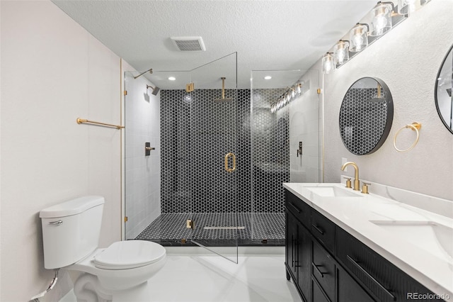 1310 E Amherst Ave, Englewood, CO 80113 - bathroom with a shower stall, double vanity, a textured ceiling, and tile patterned floors