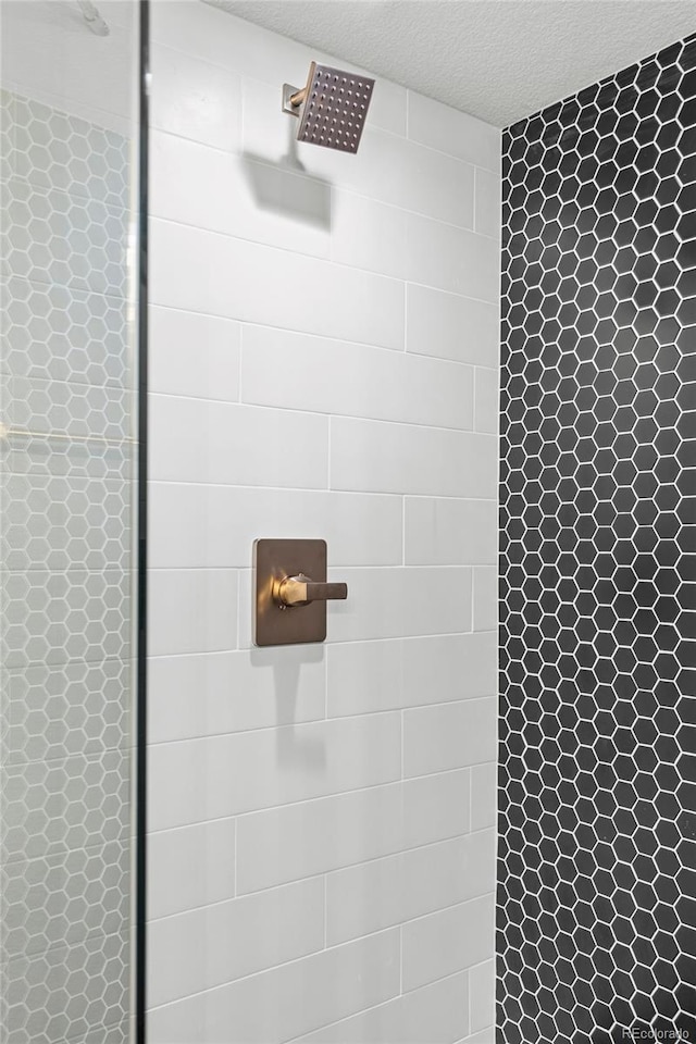 1310 E Amherst Ave, Englewood, CO 80113 - bathroom view of a tile shower and a textured ceiling
