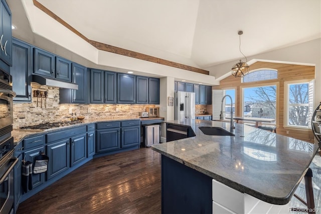 10044 E 146th Pl, Brighton, CO 80602 - kitchen with a sink, stainless steel appliances, under cabinet range hood, vaulted ceiling, and blue cabinets