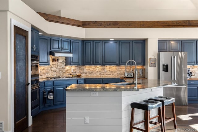 10044 E 146th Pl, Brighton, CO 80602 - kitchen featuring blue cabinets, dark wood-style flooring, under cabinet range hood, and stainless steel appliances