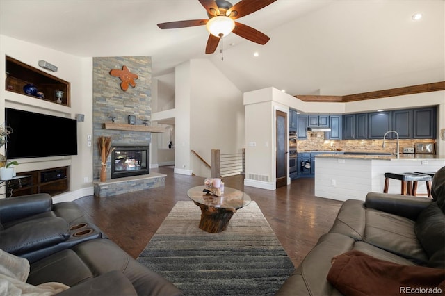 10044 E 146th Pl, Brighton, CO 80602 - living room featuring ceiling fan, dark wood-style floors, high vaulted ceiling, and a fireplace