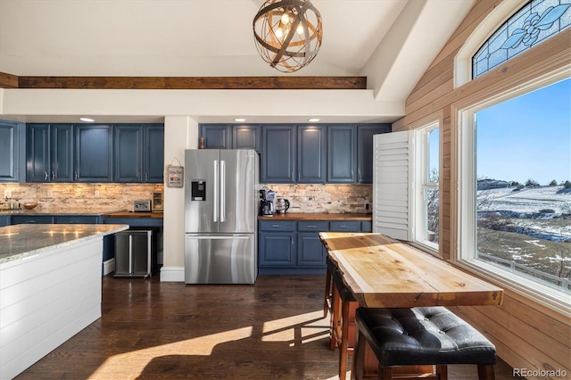 10044 E 146th Pl, Brighton, CO 80602 - kitchen with backsplash, dark wood-style flooring, blue cabinets, stainless steel fridge with ice dispenser, and butcher block counters