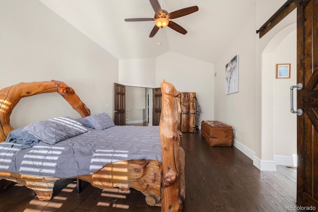 10044 E 146th Pl, Brighton, CO 80602 - bedroom with a barn door, arched walkways, baseboards, wood finished floors, and vaulted ceiling