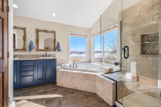 10044 E 146th Pl, Brighton, CO 80602 - full bath with wood finished floors, a bath, a sink, a stall shower, and vaulted ceiling