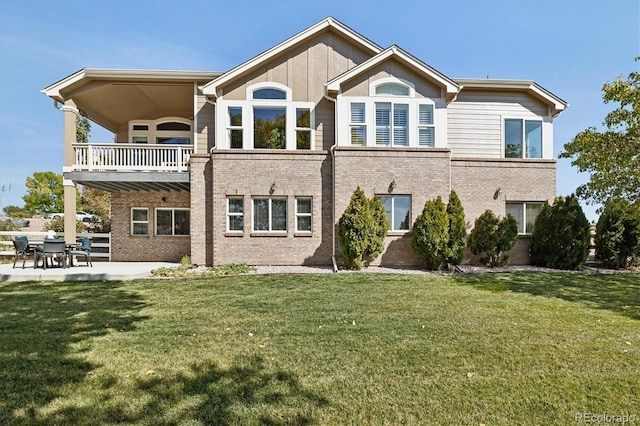 10044 E 146th Pl, Brighton, CO 80602 - back of property featuring a yard, a patio area, brick siding, and a balcony