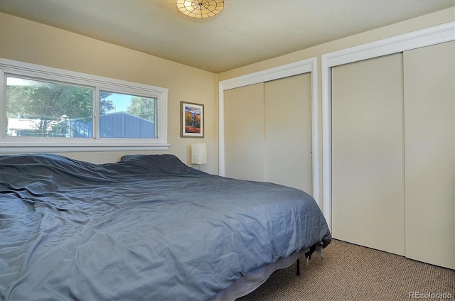 carpeted bedroom with multiple closets