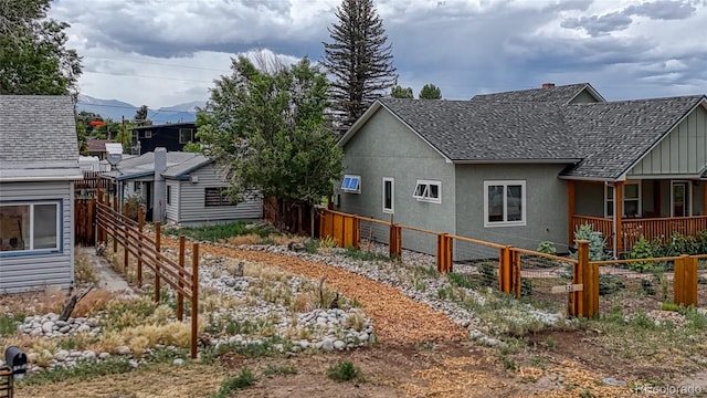 1320 H St, Salida, CO 81201 - view of side of property featuring a fenced backyard, stucco siding, and a mountain view