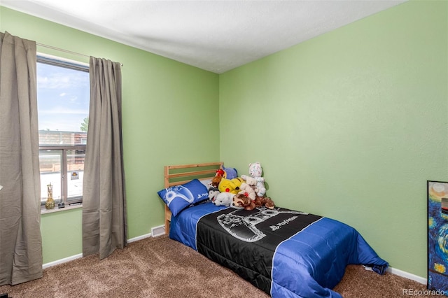 bedroom with carpet floors, a textured ceiling, and multiple windows