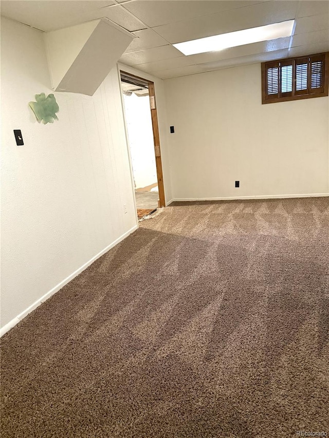 basement with carpet flooring and a drop ceiling