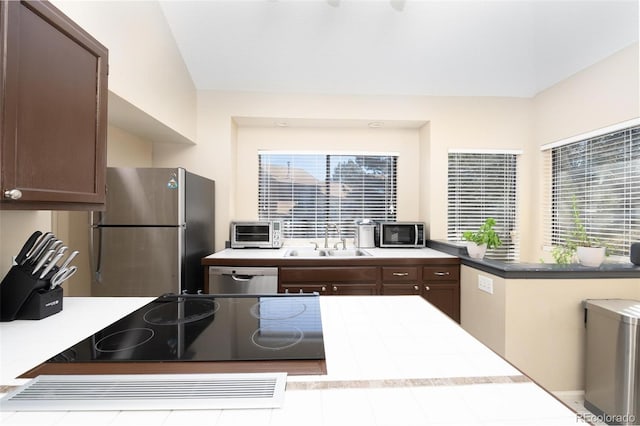 kitchen with dark brown cabinets, sink, and appliances with stainless steel finishes