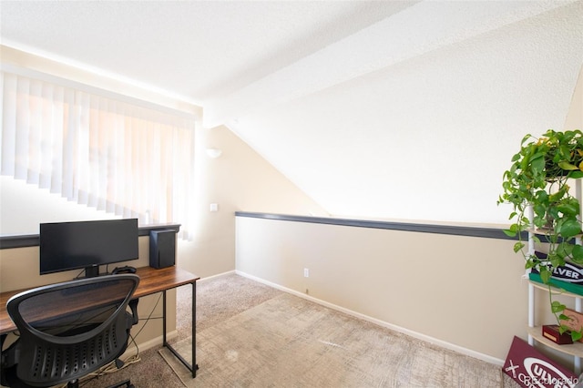 home office featuring light colored carpet and vaulted ceiling