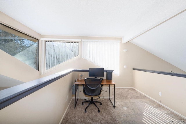 carpeted office space featuring vaulted ceiling with beams