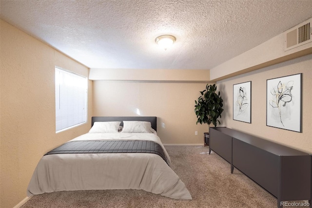 bedroom with carpet flooring and a textured ceiling