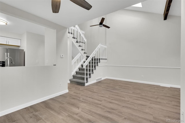 14243 E Radcliff Cir, Aurora, CO 80015 - unfurnished living room featuring ceiling fan, stairs, and wood finished floors