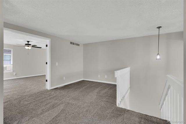 14243 E Radcliff Cir, Aurora, CO 80015 - empty room with dark carpet, a ceiling fan, and a textured ceiling