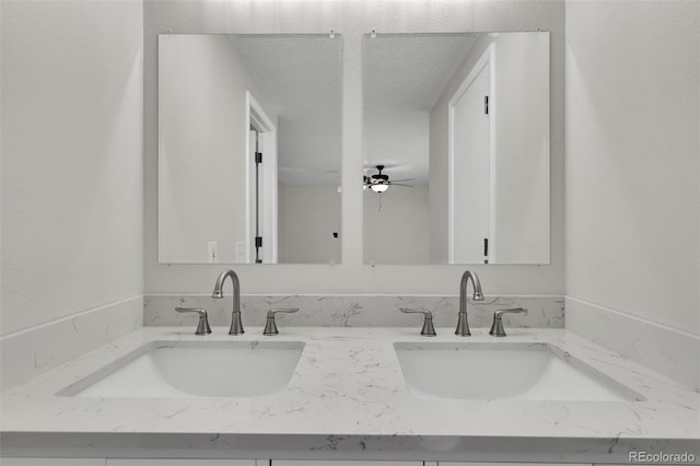 14243 E Radcliff Cir, Aurora, CO 80015 - bathroom featuring double vanity, a textured ceiling, and a ceiling fan