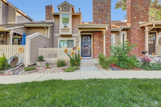 14243 E Radcliff Cir, Aurora, CO 80015 - view of front of property featuring a chimney, cooling unit, and brick siding