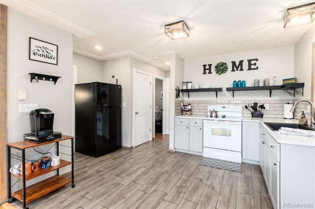 159 Lake Rd, Idaho Springs, CO 80452 - kitchen with freestanding refrigerator, electric range, open shelves, a sink, and light countertops