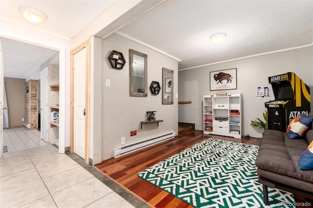 159 Lake Rd, Idaho Springs, CO 80452 - living area with a baseboard heating unit, tile patterned floors, ornamental molding, and a textured ceiling