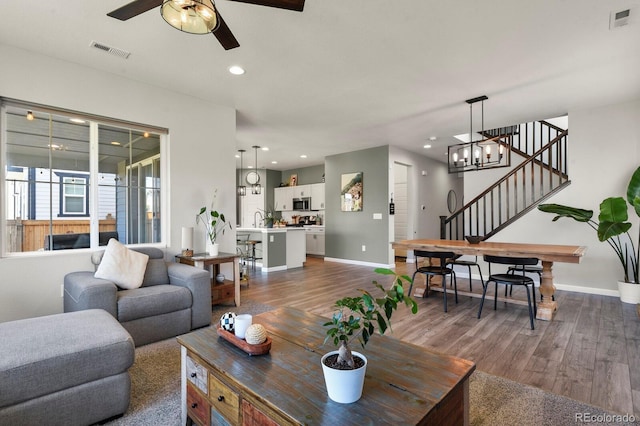 27893 E 6th Pl, Aurora, CO 80018 - living room with ceiling fan, dark wood-style floors, baseboards, and recessed lighting