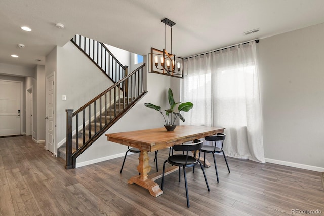 27893 E 6th Pl, Aurora, CO 80018 - dining space with stairway, wood finished floors, baseboards, a chandelier, and recessed lighting