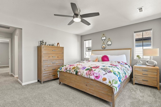 27893 E 6th Pl, Aurora, CO 80018 - carpeted bedroom featuring multiple windows, baseboards, and a ceiling fan