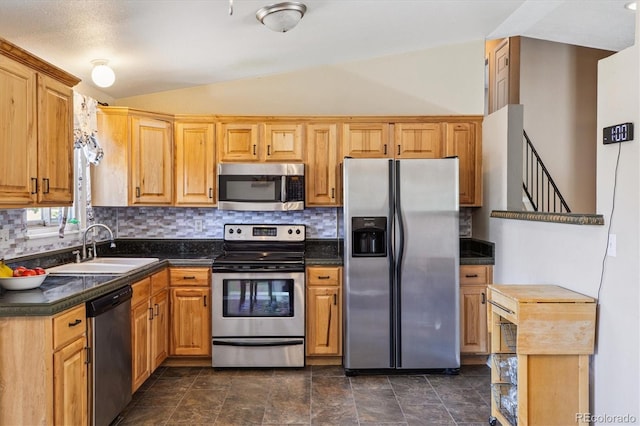 19061 E Oxford Dr, Aurora, CO 80013 - kitchen with stainless steel appliances, vaulted ceiling, dark countertops, and backsplash