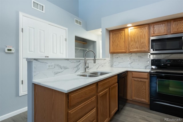 kitchen featuring black appliances, decorative backsplash, sink, and dark wood-type flooring