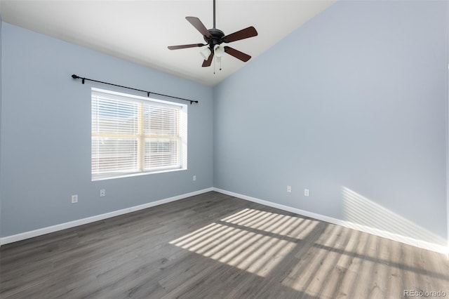 unfurnished room featuring dark hardwood / wood-style floors, vaulted ceiling, and ceiling fan