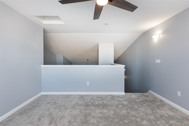 carpeted spare room featuring ceiling fan and lofted ceiling