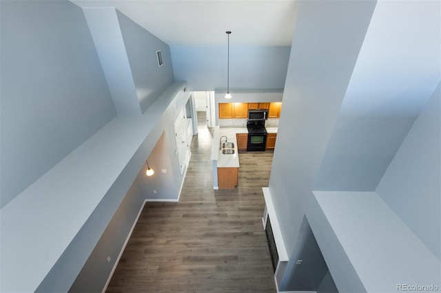 corridor with sink and hardwood / wood-style flooring