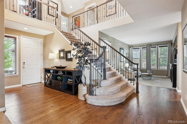 10258 Pennington Ln, Highlands Ranch, CO 80126 - entrance foyer featuring wood finished floors, stairway, and a towering ceiling
