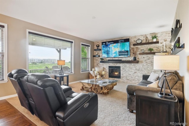 10258 Pennington Ln, Highlands Ranch, CO 80126 - living area with a stone fireplace and wood finished floors