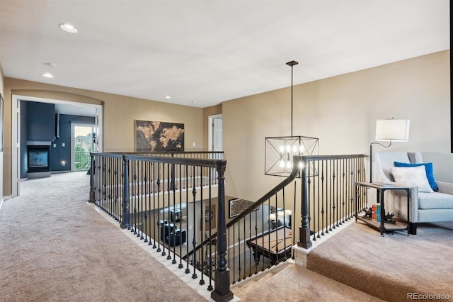 10258 Pennington Ln, Highlands Ranch, CO 80126 - hall featuring carpet floors, an upstairs landing, a chandelier, and recessed lighting