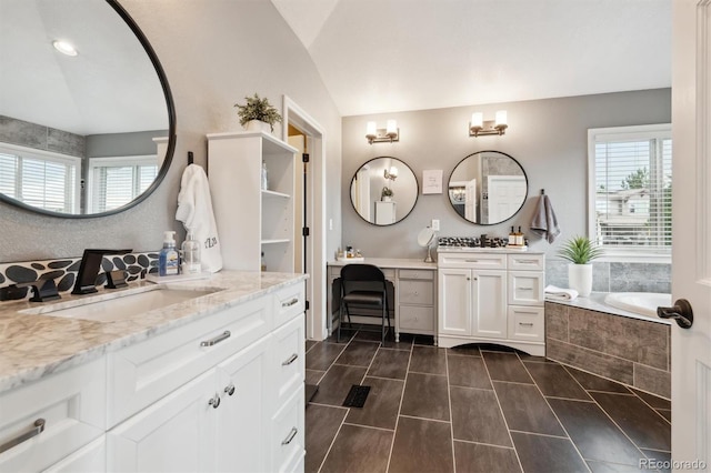 10258 Pennington Ln, Highlands Ranch, CO 80126 - full bathroom with two vanities, a garden tub, and lofted ceiling