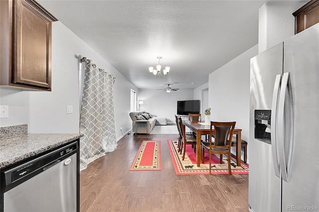 6626 Mandan Dr, Colorado Springs, CO 80925 - dining area with an inviting chandelier and dark wood finished floors
